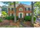 Charming two-story brick home with black shutters and manicured landscaping at 2151 Hamstead Ct, Suwanee, GA 30024