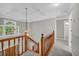 Upstairs hallway with natural light and wooden banister at 2151 Hamstead Ct, Suwanee, GA 30024