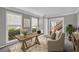 Bright home office with neutral paint, large windows, and comfortable seating area at 2151 Hamstead Ct, Suwanee, GA 30024