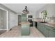 Well-lit kitchen featuring green cabinets, granite countertops, and stainless steel appliances at 2151 Hamstead Ct, Suwanee, GA 30024