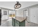 Open kitchen featuring a center island with granite countertop and access to a back patio at 2151 Hamstead Ct, Suwanee, GA 30024