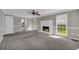 Bright living room with a fireplace, soft carpeting, and large windows at 2151 Hamstead Ct, Suwanee, GA 30024