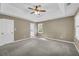 Spacious main bedroom with a tray ceiling, ceiling fan, carpet floor, and ensuite bathroom at 2151 Hamstead Ct, Suwanee, GA 30024