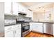 Modern kitchen with stainless steel appliances, granite countertops, and white cabinets at 2901 Lenox Ne Way # 902, Atlanta, GA 30324