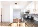 Contemporary kitchen featuring a granite countertop, stainless steel appliances, and a view to an adjacent room at 2901 Lenox Ne Way # 902, Atlanta, GA 30324