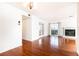 Spacious living room featuring hardwood floors, a fireplace, and a sliding glass door leading to a balcony at 2901 Lenox Ne Way # 902, Atlanta, GA 30324