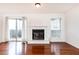 Bright living room featuring hardwood floors, a sliding glass door to a balcony, and a cozy fireplace at 2901 Lenox Ne Way # 902, Atlanta, GA 30324