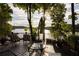 Relaxing back deck overlooking a calm lake, featuring comfortable seating, and lush greenery at 3800 Schooner Rdg, Alpharetta, GA 30005