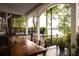 Waterfront back deck overlooking a calm lake, featuring a wooden table, iron chairs, and beautiful views at 3800 Schooner Rdg, Alpharetta, GA 30005