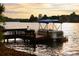 Private boat dock and pontoon boat on the lake at sunset at 3800 Schooner Rdg, Alpharetta, GA 30005
