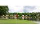 View of the golf course by the lake with lakeside houses in the background at 3800 Schooner Rdg, Alpharetta, GA 30005