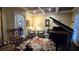 Cozy living room featuring a grand piano, coffered ceilings, and stylish seating arrangement at 3800 Schooner Rdg, Alpharetta, GA 30005