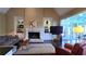 Spacious living room with a stone fireplace, built-in shelves, and large windows offering ample natural light at 3800 Schooner Rdg, Alpharetta, GA 30005