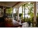 Covered patio featuring ample seating and views of mature trees and the lake at 3800 Schooner Rdg, Alpharetta, GA 30005