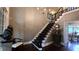 Elegant staircase with dark wood rails, complemented by high ceilings and sophisticated decor at 3800 Schooner Rdg, Alpharetta, GA 30005