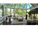 Bright sunroom with floor-to-ceiling windows, comfortable seating, and lush plants, perfect for relaxation at 3800 Schooner Rdg, Alpharetta, GA 30005