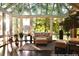 Bright sunroom features large windows, hardwood floors, and comfortable seating for relaxing and enjoying the view at 3800 Schooner Rdg, Alpharetta, GA 30005