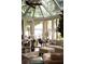 Beautiful sunroom featuring floor to ceiling windows providing views of a serene lake at 3800 Schooner Rdg, Alpharetta, GA 30005