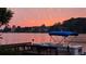 Beautiful waterfront view at sunset featuring a boat docked at the pier, perfect for serene living at 3800 Schooner Rdg, Alpharetta, GA 30005
