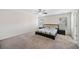 This bedroom offers a ceiling fan, neutral paint, plush carpets, and a bed with floral sheets at 522 Spring View Dr, Woodstock, GA 30188