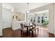 Dining area with hardwood floors and natural light streaming through windows, connects to the living space at 522 Spring View Dr, Woodstock, GA 30188