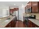 Modern kitchen features granite counters, stainless steel appliances, and dark wood cabinets at 522 Spring View Dr, Woodstock, GA 30188