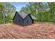 New construction with covered patio in a wooded location with red dirt at 1687 Harmony Rd, Temple, GA 30179