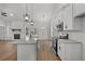 Bright kitchen with white cabinets, granite counters, and stainless steel appliances, flowing to living area at 1687 Harmony Rd, Temple, GA 30179