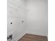 View of a laundry room with white walls, wood-look floors and wire shelving at 1687 Harmony Rd, Temple, GA 30179