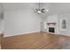 Open-concept living room featuring hardwood floors, a modern fireplace, and high ceilings at 1687 Harmony Rd, Temple, GA 30179