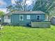 The rear exterior shows the back door and outdoor utilities on the grassy lawn at 2404 Shallowford Ter, Atlanta, GA 30341