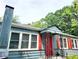 A quaint blue house with red shutters, a chimney, and a striking red front door at 2404 Shallowford Ter, Atlanta, GA 30341