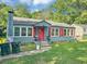 Image features a blue home with red shutters, a chimney, and green waste cans at 2404 Shallowford Ter, Atlanta, GA 30341
