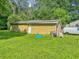 A detached yellow garage on a grassy lot is perfect for storage and vehicles at 2404 Shallowford Ter, Atlanta, GA 30341