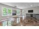 Open basement area with marbelized epoxy flooring, bar with wine cooler, and an exterior view at 2990 Hearthstone Dr, Cumming, GA 30041