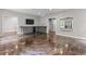 Spacious basement featuring a wet bar, a TV, and beautiful marbelized epoxy flooring at 2990 Hearthstone Dr, Cumming, GA 30041