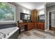 Elegant bathroom with dual vanities, soaking tub, and large window offering wooded view at 2990 Hearthstone Dr, Cumming, GA 30041