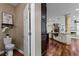 Powder room featuring decorative wallpaper, a pedestal sink, and adjacent kitchen view at 2990 Hearthstone Dr, Cumming, GA 30041
