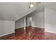 Bedroom with sloping ceilings features hardwood floors and is freshly painted with neutral colors at 2990 Hearthstone Dr, Cumming, GA 30041
