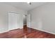 This bedroom features hardwood floors, a closet and a door to an ensuite bathroom at 2990 Hearthstone Dr, Cumming, GA 30041