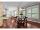 Elegant dining area with a chandelier, hardwood floors, and views of the backyard at 2990 Hearthstone Dr, Cumming, GA 30041