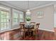 Cozy dining area featuring a chandelier, hardwood floors, and scenic views at 2990 Hearthstone Dr, Cumming, GA 30041
