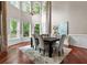 Formal dining room with wainscoting, soaring windows, and elegant chandelier at 2990 Hearthstone Dr, Cumming, GA 30041