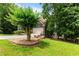 Secluded property with a long driveway, lush trees and landscaping surrounding the home at 2990 Hearthstone Dr, Cumming, GA 30041