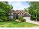 Charming two-story home with stone accents, attached garage, lush lawn and mature trees at 2990 Hearthstone Dr, Cumming, GA 30041