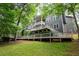 Expansive deck wraps around this home, providing multiple outdoor living and entertaining areas in a private setting at 2990 Hearthstone Dr, Cumming, GA 30041
