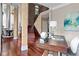 Stately foyer featuring hardwood floors, exposed brick, statement lighting, and access to dining room at 2990 Hearthstone Dr, Cumming, GA 30041