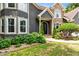 Beautiful home exterior featuring stone accents, manicured landscaping, and an arched front door at 2990 Hearthstone Dr, Cumming, GA 30041