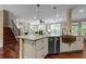 Kitchen island with stainless steel appliances, copper sink, and granite countertops at 2990 Hearthstone Dr, Cumming, GA 30041