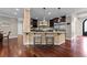 Kitchen island with granite countertops, pendant lighting, barstool seating, and stainless steel appliances at 2990 Hearthstone Dr, Cumming, GA 30041